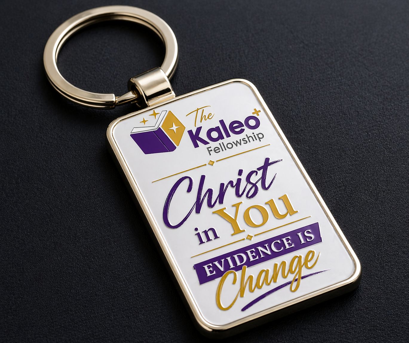 Gold rectangular Kaleo Fellowship keyring with the Christ in You message